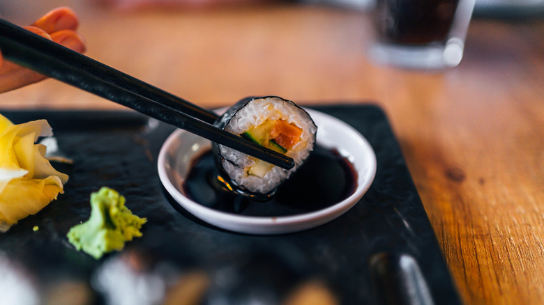 sushi dipped in soy sauce