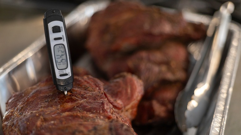 A digital thermometer measuring the temperature of cooked meat