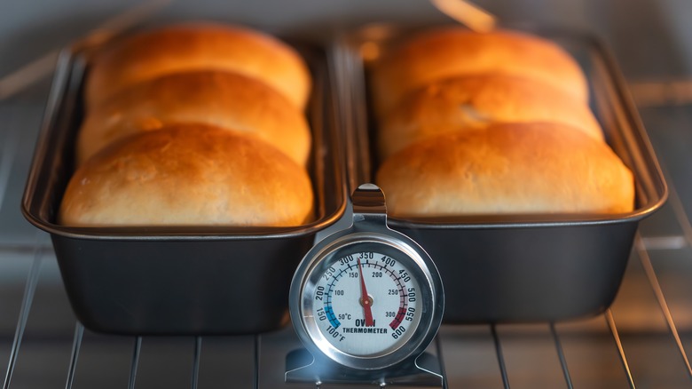 Bread loaves baking with an oven thermometer