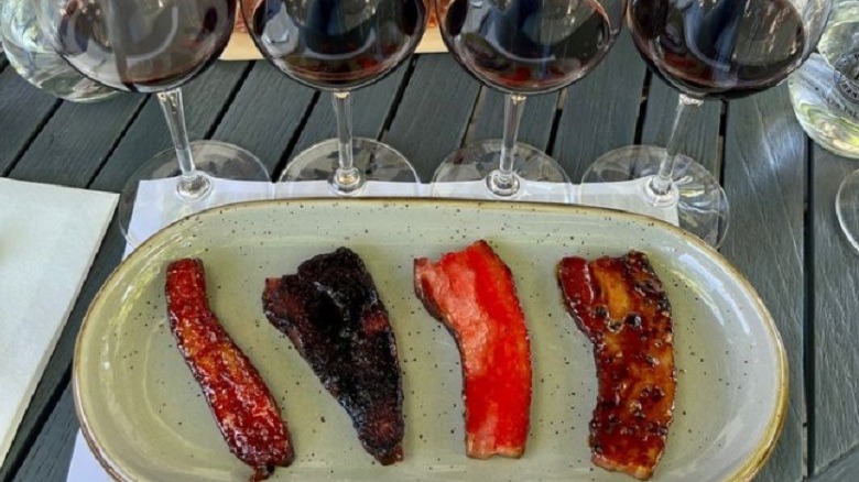 Plate of bacons with glasses of wine