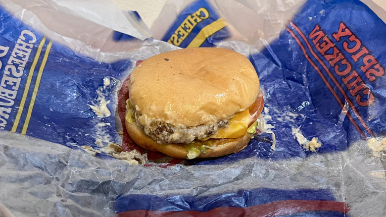 A California Classic Double Cheeseburger from Carl's Jr. sitting on its wrapper