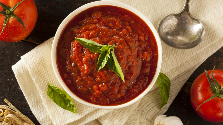 Marinara sauce in bowl, tomatoes