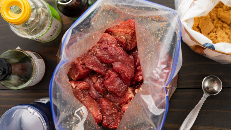 Meat soaking in a marinade in plastic bag