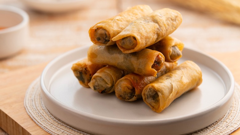 stacked spring rolls on plate