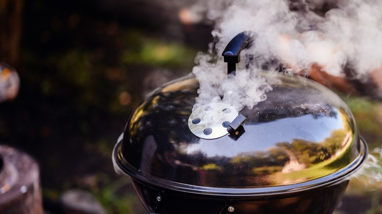 A closed grill with open grates smokes freely