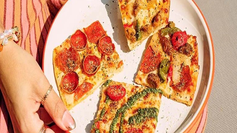 Four slices of tavern-style pizza from Pizza Hut are on display.