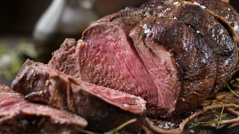 Close up of sliced prime rib sprinkled with salt