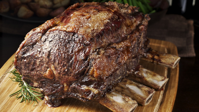 Bone-in prime rib resting on a cutting board