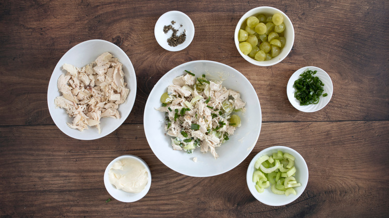 chicken salad ingredients in various white bowls