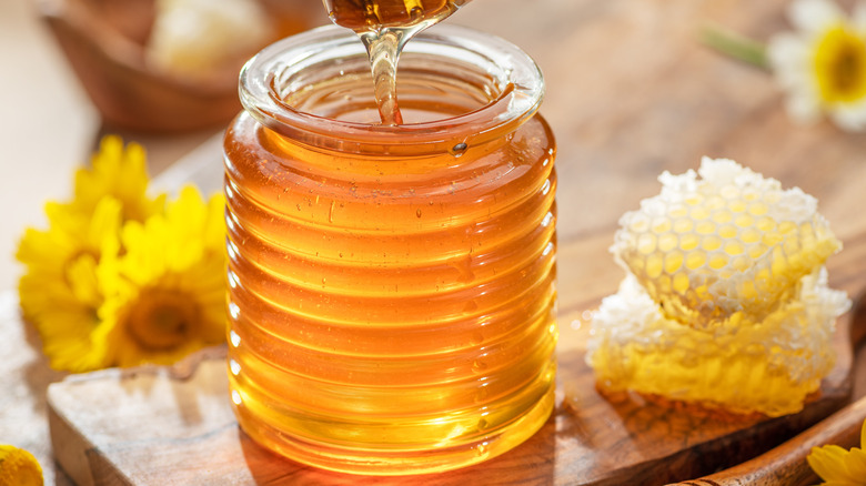 Jar of honey on wood