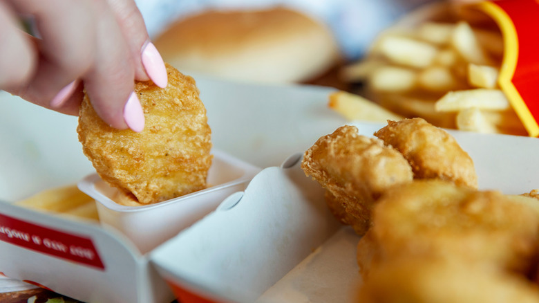 dipping chicken nuggets in sauce