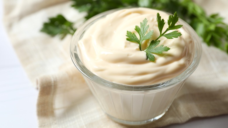 A glass ramekin of mayonnaise