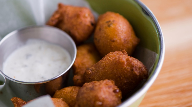 Hush puppies with dipping sauce in bowl