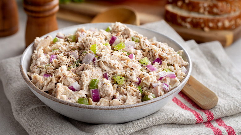 Bowl of tuna salad on folded tablecloth