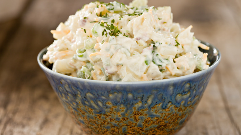 blue bowl heaped with potato salad