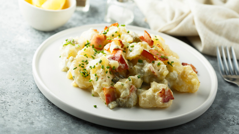plate of potato salad with bacon and chives