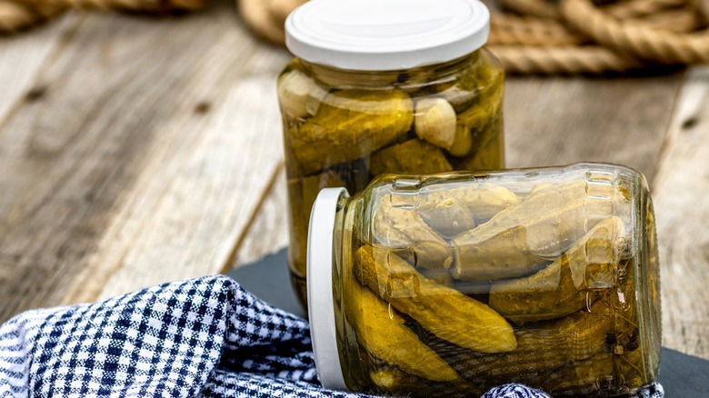 two jars of pickles on table