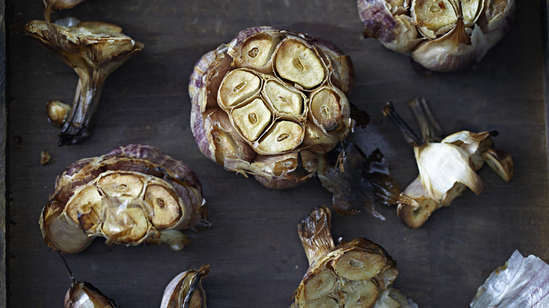 Roasted garlic on dark grey surface