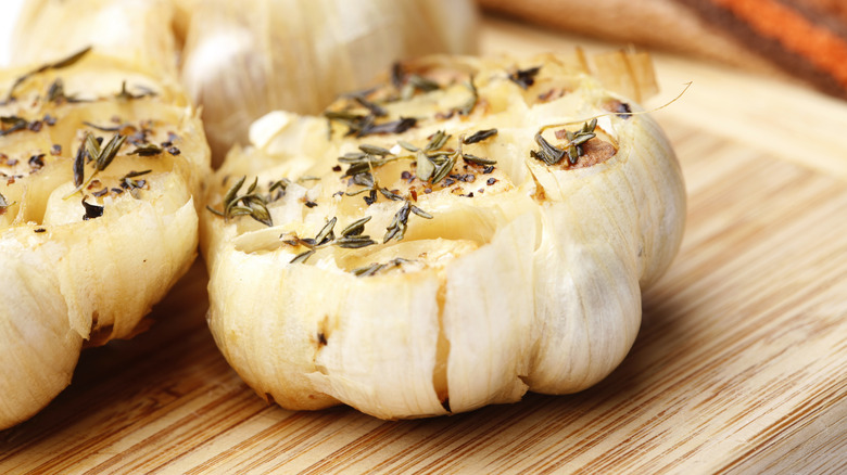roasted garlic head on board