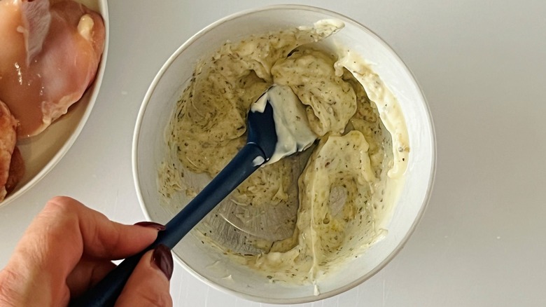 stirring seasoned mayonnaise in bowl
