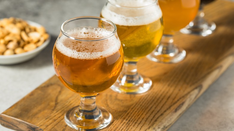 Chalices of IPA beer on a wooden plank