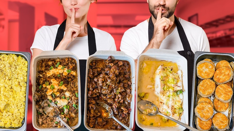 Buffet workers with food trays, making shh gesture