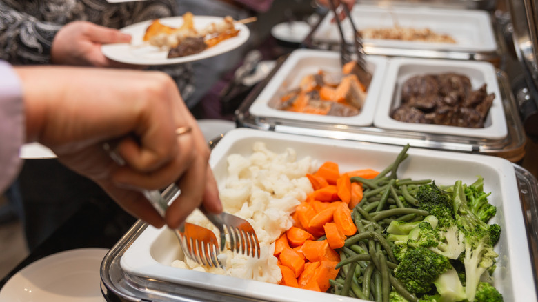 Person serving self at buffet