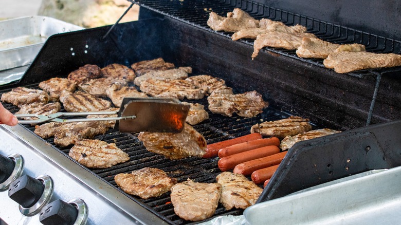 Grilling pork chops and hot dogs