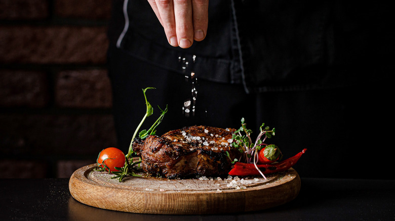 Man salting pork chops