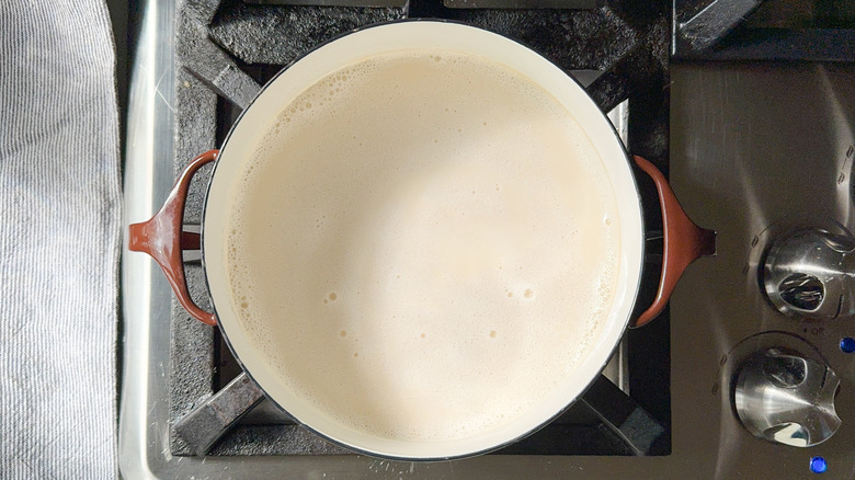 Almond milk simmering in saucepot on stove