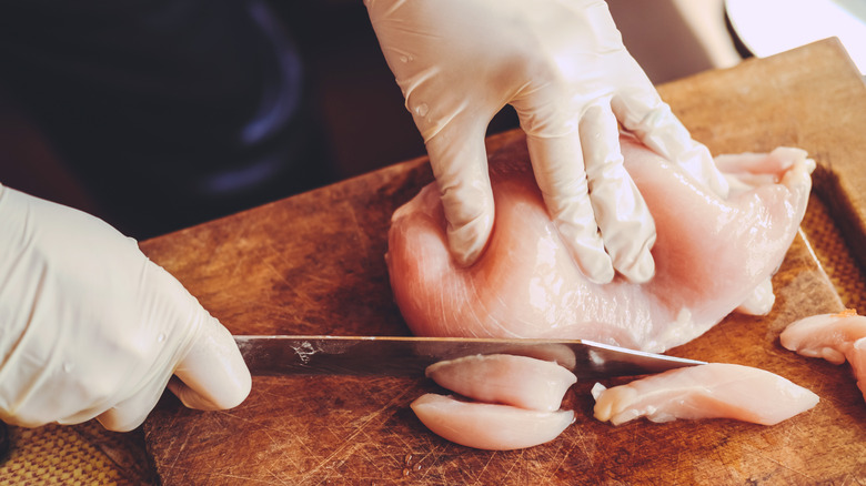 Cutting raw chicken