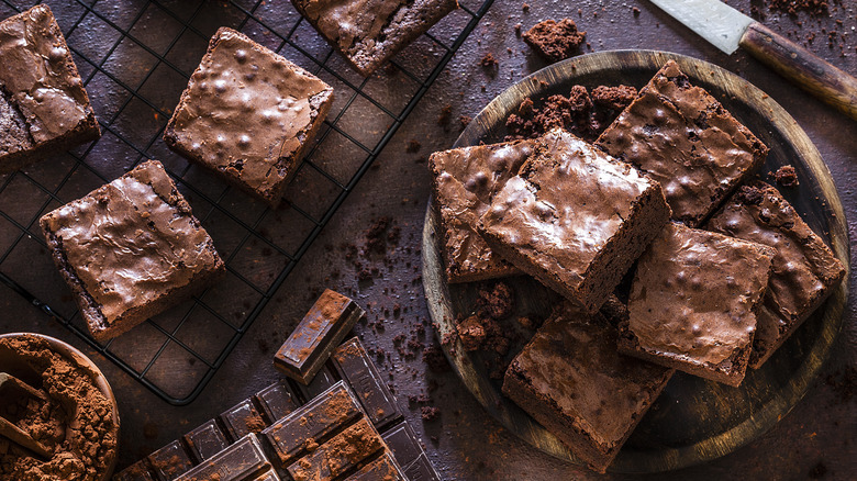 Freshly baked brownies on cooling rack and plate