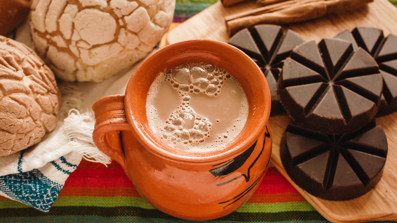 Mexican hot chocolate with solid drinking chocolate tablets and concha pastries
