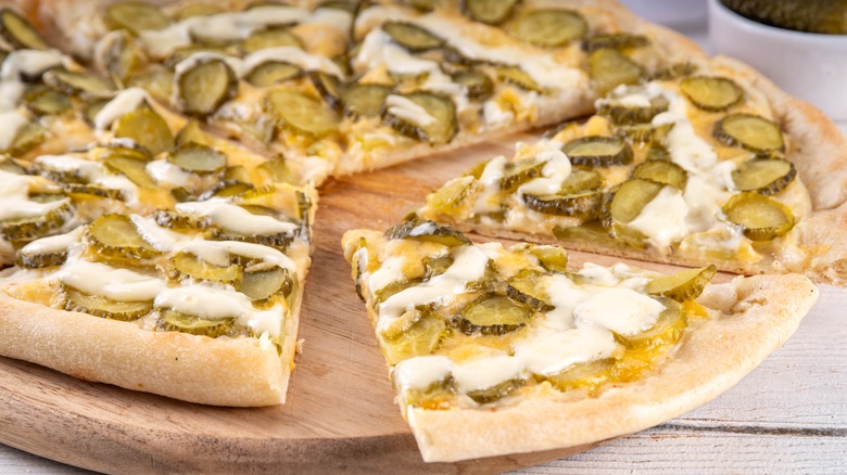 White pizza with pickle slices on top