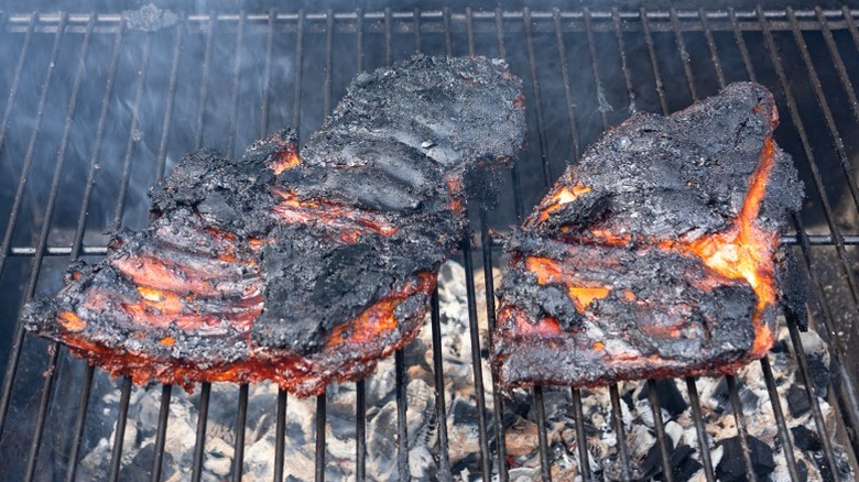 Burned barbecue ribs covered in black char