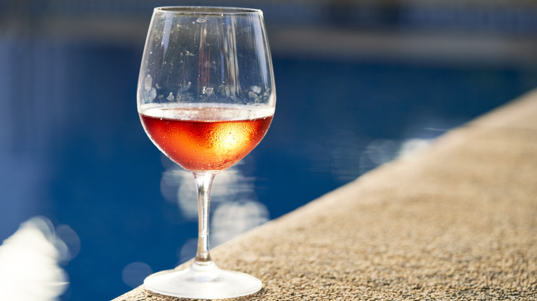 orange wine by swimming pool