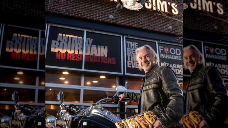 Biker Jim outside his restaurant with hot dogs