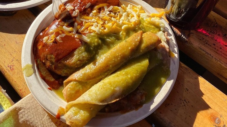 A plate with beef taquitos with red and green sauces from Cielito Lindo in Los Angeles