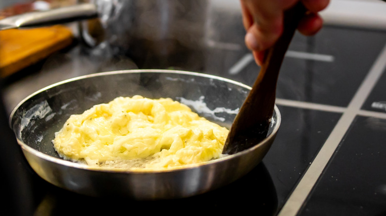 Stirring eggs in pan