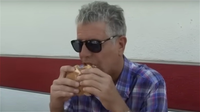 Anthony Bourdain holding a burger