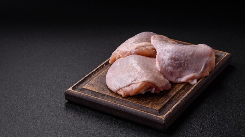 Chicken thighs on a cutting board