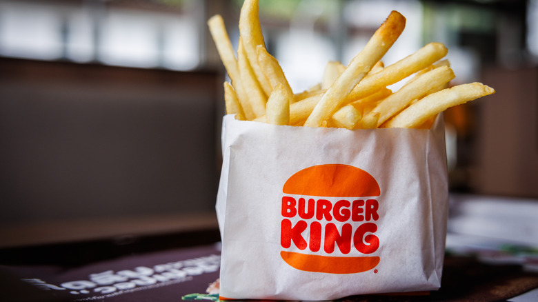 fries poking out of Burger King paper packaging