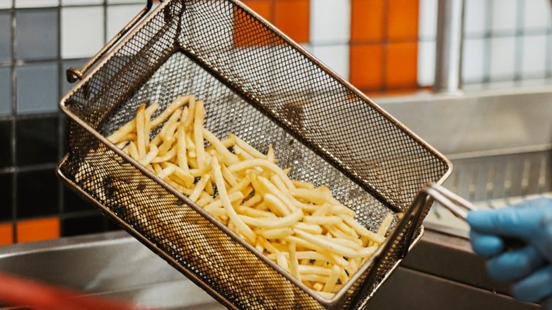 Fries in a restaurant fryer basket