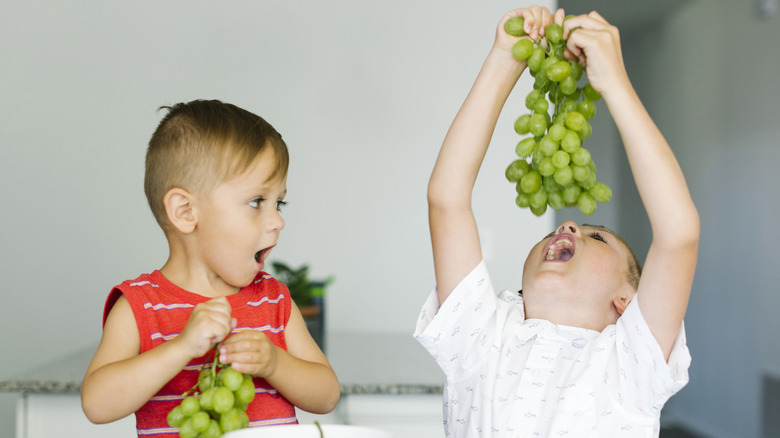 Children eating cotton candy grapes