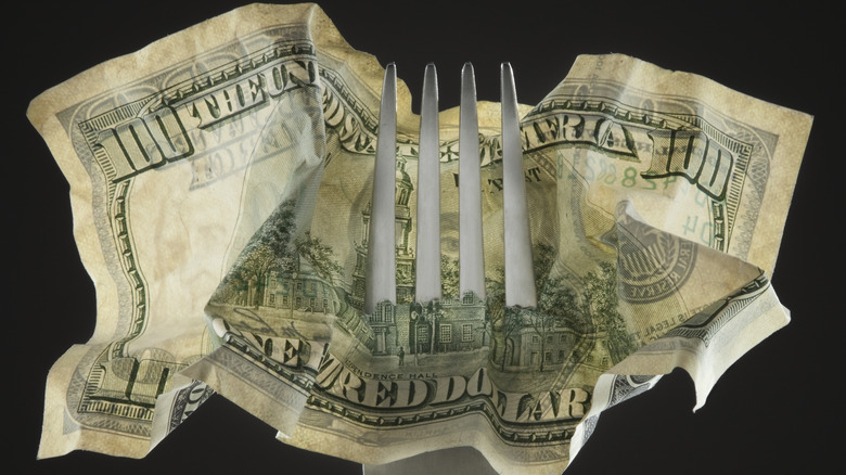 Fork through $100 bill