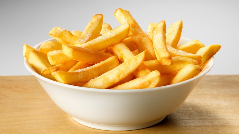 white bowl full of french fries