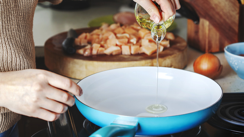 Pouring oil into a pan