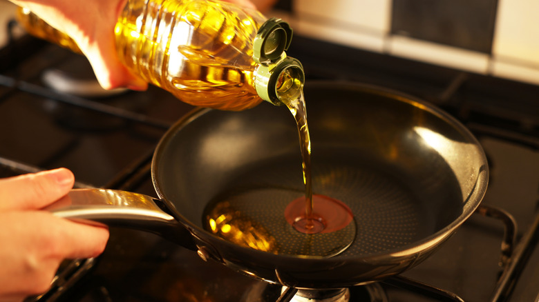 Pouring oil in a pan