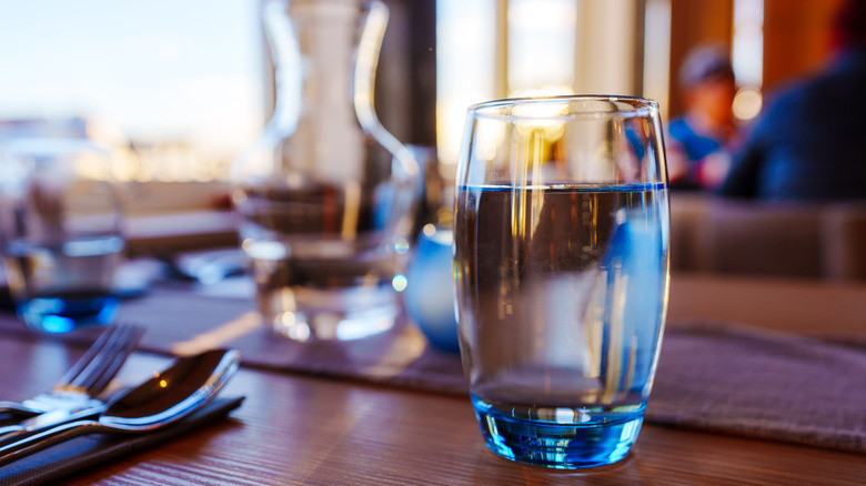 a full glass of water on a restaurant table