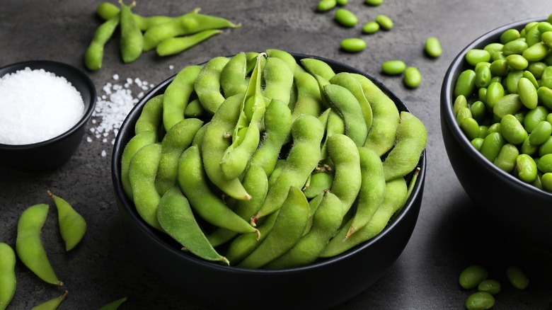 Edamame pods and salt in bowls